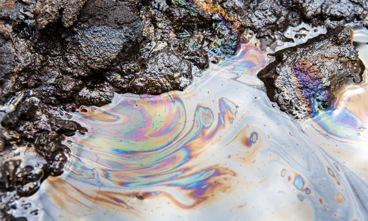 Runoff from Tar Sands in water.