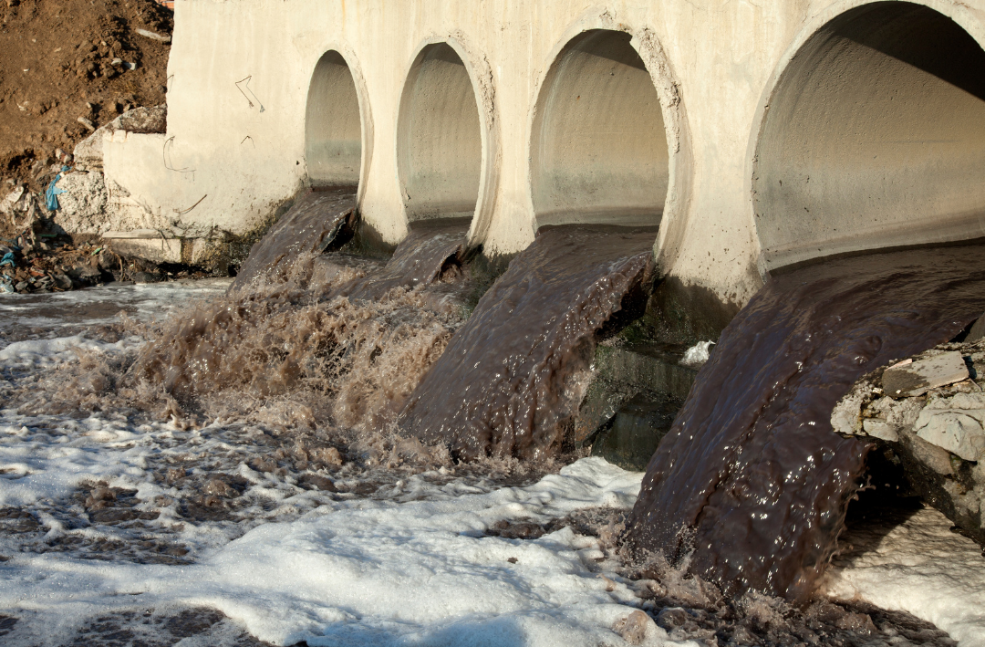 Dirty water flowing out of structure.